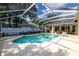 Backyard pool with screened enclosure and a covered patio area with furniture at 4612 River Overlook Dr, Valrico, FL 33596