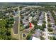 Aerial view of the property with a large pond and green trees in the surrounding area at 490 Knight Dr, Tarpon Springs, FL 34688