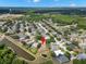 Wide aerial view of the property showing its location in the neighborhood with a pond at 490 Knight Dr, Tarpon Springs, FL 34688