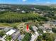 An aerial view of the property showcasing a pool, pond, and surrounding greenery at 490 Knight Dr, Tarpon Springs, FL 34688