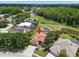 Aerial view of a charming home with a screened-in pool, surrounded by lush greenery at 490 Knight Dr, Tarpon Springs, FL 34688