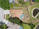 Aerial view of the home with a pool, patio, and well-maintained backyard at 490 Knight Dr, Tarpon Springs, FL 34688