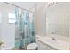 Small bathroom with a single-sink vanity and a shower with patterned curtain at 490 Knight Dr, Tarpon Springs, FL 34688