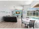 Open-concept living room with views of pool and access to dining area at 490 Knight Dr, Tarpon Springs, FL 34688