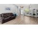 Comfortable living room featuring wood floors, a leather reclining sofa, and a view of the entryway at 490 Knight Dr, Tarpon Springs, FL 34688