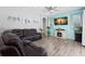 Cozy living room with TV, fireplace, and modern furnishings at 490 Knight Dr, Tarpon Springs, FL 34688