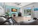 Living room features a fireplace, TV, and sliding doors to the screened-in pool at 490 Knight Dr, Tarpon Springs, FL 34688