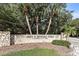 Stone entrance to Fred H. Howard Park with mature trees and landscaping at 490 Knight Dr, Tarpon Springs, FL 34688