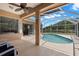 Screened-in pool area with covered patio seating, perfect for outdoor entertaining at 490 Knight Dr, Tarpon Springs, FL 34688