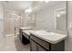 Modern bathroom featuring a double sink vanity and glass-enclosed shower at 5344 Sylvester Loop, Tampa, FL 33610