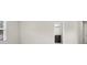 Bedroom with a light gray wall, light colored carpet, and a view into the bathroom at 5344 Sylvester Loop, Tampa, FL 33610