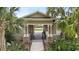 View of the clubhouse featuring a gated area with landscaping and a pond at 5344 Sylvester Loop, Tampa, FL 33610