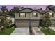 Charming two-story townhomes with individual garages, lush landscaping, and well-maintained driveways at 5344 Sylvester Loop, Tampa, FL 33610