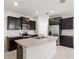 Well-equipped kitchen featuring stainless steel appliances and dark wooden cabinets at 5344 Sylvester Loop, Tampa, FL 33610