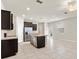 Spacious kitchen area featuring stainless steel appliances, tile flooring, and a kitchen island at 5344 Sylvester Loop, Tampa, FL 33610