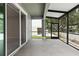 View of the screened-in patio with access to the outside with concrete flooring at 5344 Sylvester Loop, Tampa, FL 33610
