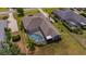 Aerial view of the property featuring a screened pool, mature landscaping and expansive lawn at 5507 Keeler Oak St, Lithia, FL 33547
