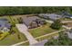 Expansive property featuring mature trees, manicured lawns, a screened pool, and a multi-car driveway at 5507 Keeler Oak St, Lithia, FL 33547