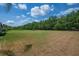 Spacious backyard showcasing a well-kept lawn and mature trees, perfect for outdoor activities and gatherings at 5507 Keeler Oak St, Lithia, FL 33547