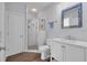 Clean bathroom with a glass-enclosed shower, modern vanity, and stylish rectangular mirror at 5507 Keeler Oak St, Lithia, FL 33547