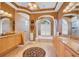 Luxurious bathroom with dual vanities, soaking tub, and arched windows for natural light at 5507 Keeler Oak St, Lithia, FL 33547