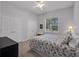 Well lit bedroom with a queen sized bed, ceiling fan, and double door closet at 5507 Keeler Oak St, Lithia, FL 33547