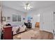 Comfortable bedroom with a ceiling fan, wood-look floors, and a bathroom en suite at 5507 Keeler Oak St, Lithia, FL 33547