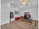 Spacious bonus room showcasing wood floors, a vaulted ceiling, and modern entertainment setup at 5507 Keeler Oak St, Lithia, FL 33547