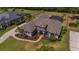 Aerial view of a luxurious home with manicured landscaping, mature trees, and a circular driveway at 5507 Keeler Oak St, Lithia, FL 33547