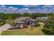 Well-manicured lawn and sculpted landscaping, complemented by elegant architectural details and mature trees at 5507 Keeler Oak St, Lithia, FL 33547
