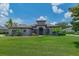 Stunning single-story home with arched windows, lush landscaping, and a well-manicured front lawn at 5507 Keeler Oak St, Lithia, FL 33547
