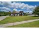 Exterior view showcasing manicured lawns, mature landscaping, and a welcoming facade at 5507 Keeler Oak St, Lithia, FL 33547