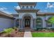 Inviting front entrance with decorative columns and well-manicured landscaping, enhancing curb appeal at 5507 Keeler Oak St, Lithia, FL 33547