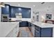 Well-appointed kitchen featuring blue cabinets, white countertops, and stainless steel appliances at 5507 Keeler Oak St, Lithia, FL 33547