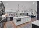 Open-concept kitchen with island and breakfast bar, leading to dining area and living space at 5507 Keeler Oak St, Lithia, FL 33547