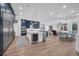 Open-concept kitchen with blue cabinets, stainless steel appliances, and seamless flow to the dining area at 5507 Keeler Oak St, Lithia, FL 33547