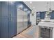 Contemporary kitchen boasts stainless steel appliances, blue cabinetry, and a bright, open layout at 5507 Keeler Oak St, Lithia, FL 33547