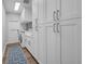 Well-equipped laundry room with white cabinetry, washer, dryer, and plenty of storage at 5507 Keeler Oak St, Lithia, FL 33547