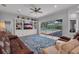 Bright and airy living room featuring built-in shelving, opening up to the pool area at 5507 Keeler Oak St, Lithia, FL 33547