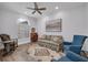 Cozy living room area featuring a beautiful area rug, comfortable seating, a ceiling fan, and abundant natural light at 5507 Keeler Oak St, Lithia, FL 33547