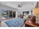 Spacious living room open floor plan with blue rug, ceiling fan, and outdoor view at 5507 Keeler Oak St, Lithia, FL 33547