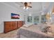 Comfortable main bedroom with dresser, tile floors, ceiling fan, and a view of the pool at 5507 Keeler Oak St, Lithia, FL 33547