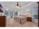 Spacious main bedroom with tile floors, large windows, and ceiling fan at 5507 Keeler Oak St, Lithia, FL 33547