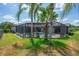 Inviting screened-in pool area with lounge chairs, lush landscaping, and shaded space for outdoor relaxation and entertaining at 5507 Keeler Oak St, Lithia, FL 33547