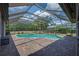 The screened in pool features an attached spa, patio, and lush landscaping at 5507 Keeler Oak St, Lithia, FL 33547