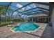 Relaxing pool area featuring a spa and ample seating under a screened enclosure at 5507 Keeler Oak St, Lithia, FL 33547