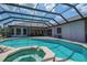 Large in ground pool with an attached spa, patio, and screened enclosure at 5507 Keeler Oak St, Lithia, FL 33547