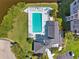 Overhead aerial view of a community pool with lounge chairs, surrounded by lush landscaping and residential buildings at 5712 Biscayne Ct # 103, New Port Richey, FL 34652
