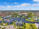 Panoramic aerial view showcasing waterfront homes, a marina, and the surrounding community under a sunny sky at 5712 Biscayne Ct # 103, New Port Richey, FL 34652
