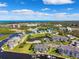 Scenic aerial view of waterfront homes, a marina, and the ocean in the distance under a bright blue sky at 5712 Biscayne Ct # 103, New Port Richey, FL 34652